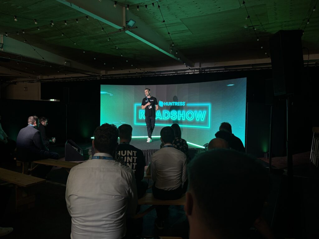 Speaker presenting during the Huntress Roadshow